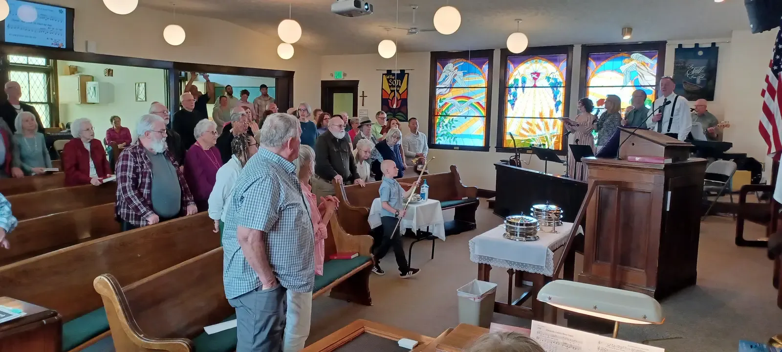 The congregation standing together in worship at Creston Christian Church
