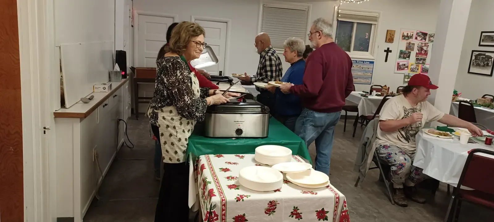 Church members serving a shared meal in the fellowship hall